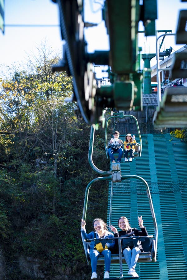 Tourists sitting on the cable car. Cable cars without protective glasses at Tianmenshan, Hunan province, Zhangjiajie. Tourists sitting on the cable car. Cable cars without protective glasses at Tianmenshan, Hunan province, Zhangjiajie.