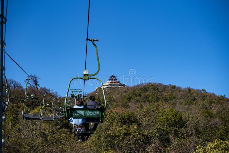 Tourists sitting on the cable car. Cable cars without protective glasses at Tianmenshan, Hunan province, Zhangjiajie. Tourists sitting on the cable car. Cable cars without protective glasses at Tianmenshan, Hunan province, Zhangjiajie.