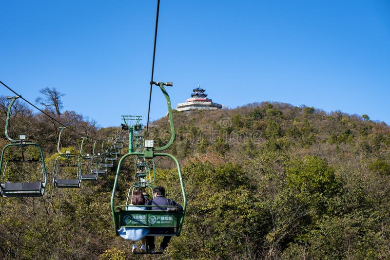 Tourists sitting on the cable car. Cable cars without protective glasses at Tianmenshan, Hunan province, Zhangjiajie. Tourists sitting on the cable car. Cable cars without protective glasses at Tianmenshan, Hunan province, Zhangjiajie.