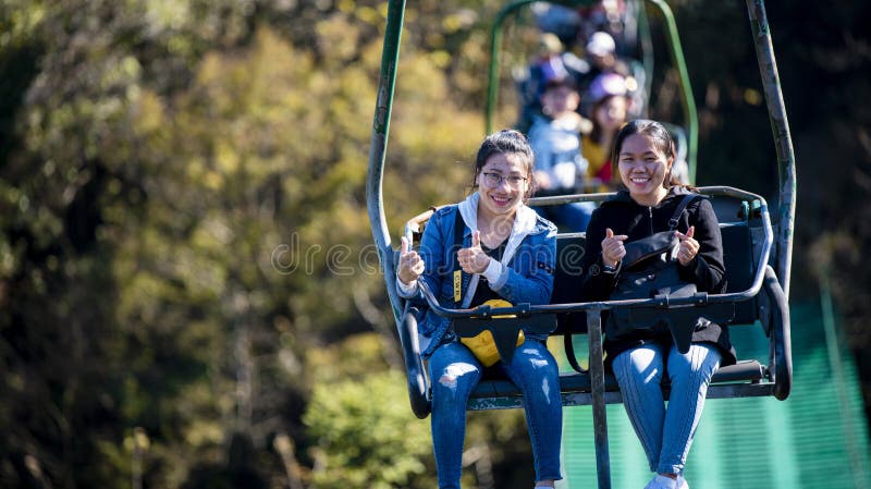 Tourists sitting on the cable car. Cable cars without protective glasses at Tianmenshan, Hunan province, Zhangjiajie. Tourists sitting on the cable car. Cable cars without protective glasses at Tianmenshan, Hunan province, Zhangjiajie.