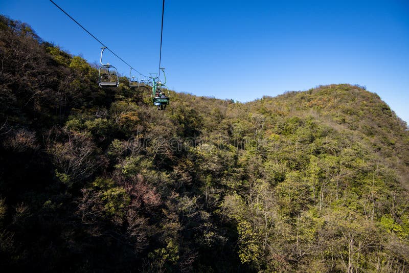 Tourists sitting on the cable car. Cable cars without protective glasses at Tianmenshan, Hunan province, Zhangjiajie. Tourists sitting on the cable car. Cable cars without protective glasses at Tianmenshan, Hunan province, Zhangjiajie.