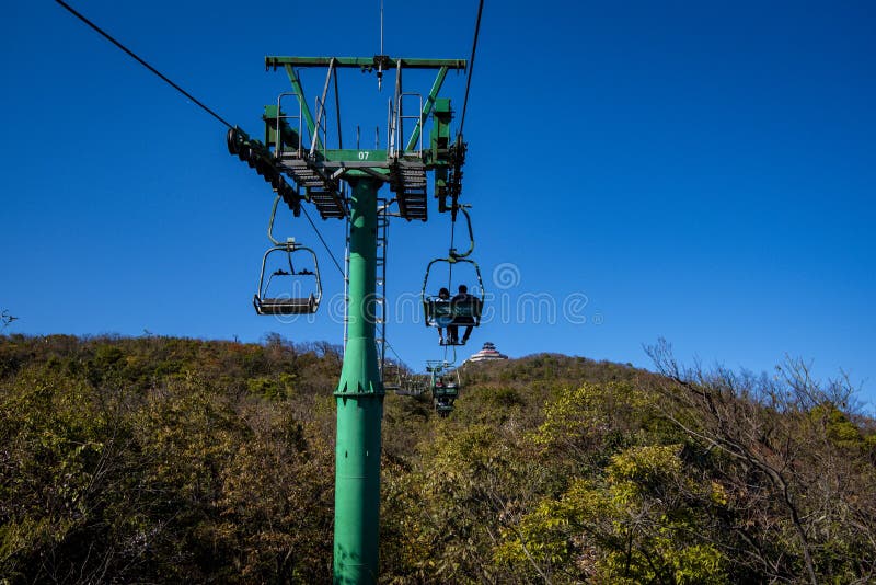 Tourists sitting on the cable car. Cable cars without protective glasses at Tianmenshan, Hunan province, Zhangjiajie. Tourists sitting on the cable car. Cable cars without protective glasses at Tianmenshan, Hunan province, Zhangjiajie.