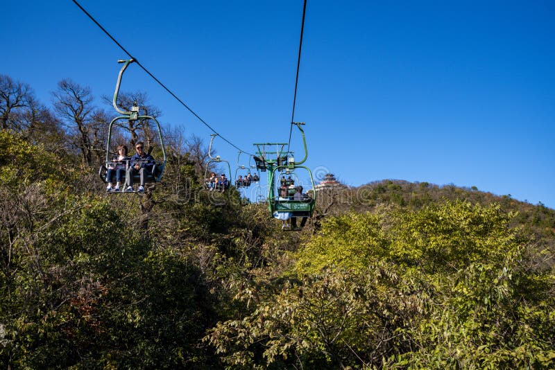 Tourists sitting on the cable car. Cable cars without protective glasses at Tianmenshan, Hunan province, Zhangjiajie. Tourists sitting on the cable car. Cable cars without protective glasses at Tianmenshan, Hunan province, Zhangjiajie.