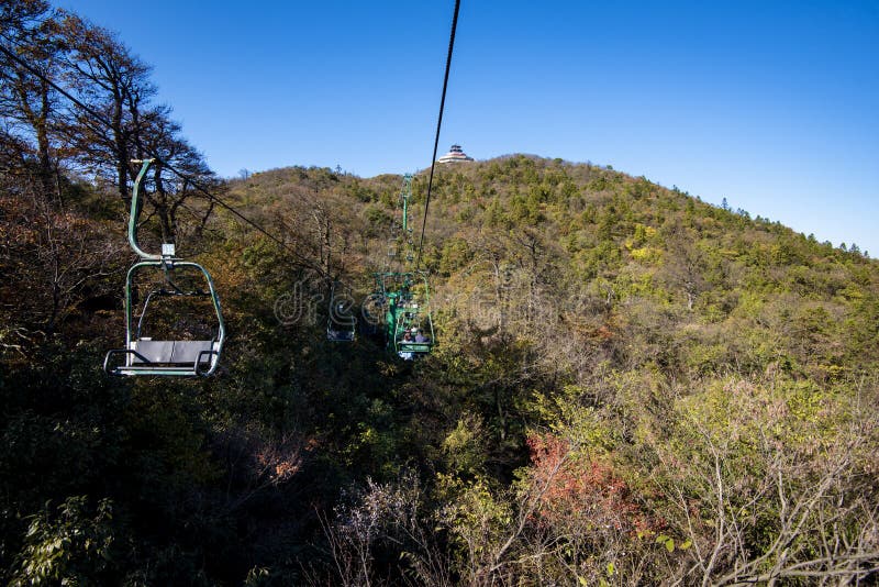 Tourists sitting on the cable car. Cable cars without protective glasses at Tianmenshan, Hunan province, Zhangjiajie. Tourists sitting on the cable car. Cable cars without protective glasses at Tianmenshan, Hunan province, Zhangjiajie.