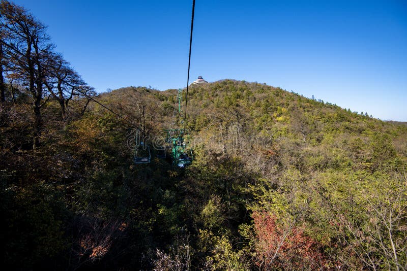 Tourists sitting on the cable car. Cable cars without protective glasses at Tianmenshan, Hunan province, Zhangjiajie. Tourists sitting on the cable car. Cable cars without protective glasses at Tianmenshan, Hunan province, Zhangjiajie.