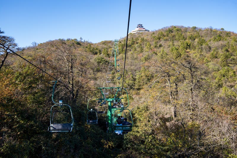 Tourists sitting on the cable car. Cable cars without protective glasses at Tianmenshan, Hunan province, Zhangjiajie. Tourists sitting on the cable car. Cable cars without protective glasses at Tianmenshan, Hunan province, Zhangjiajie.