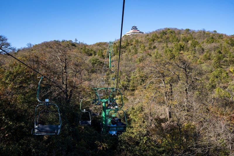 Tourists sitting on the cable car. Cable cars without protective glasses at Tianmenshan, Hunan province, Zhangjiajie. Tourists sitting on the cable car. Cable cars without protective glasses at Tianmenshan, Hunan province, Zhangjiajie.