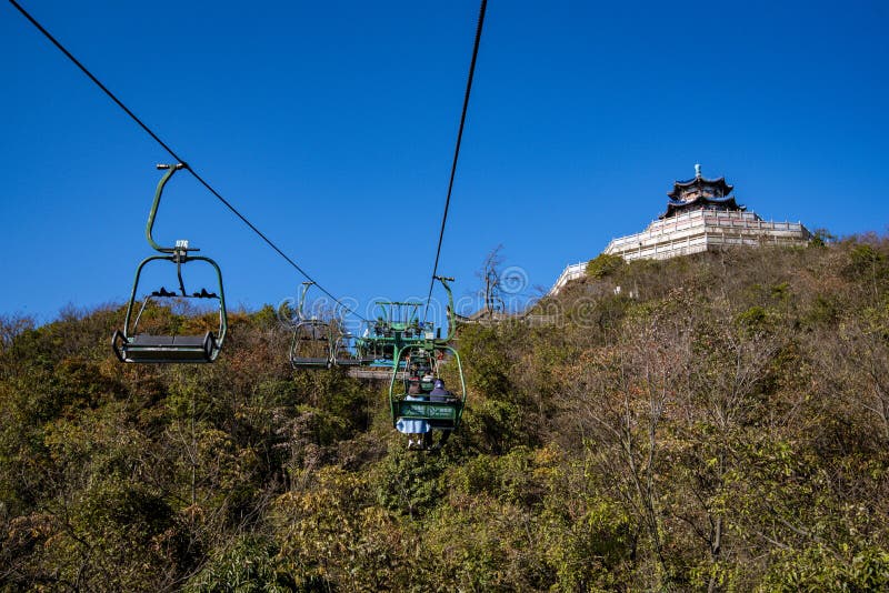 Tourists sitting on the cable car. Cable cars without protective glasses at Tianmenshan, Hunan province, Zhangjiajie. Tourists sitting on the cable car. Cable cars without protective glasses at Tianmenshan, Hunan province, Zhangjiajie.