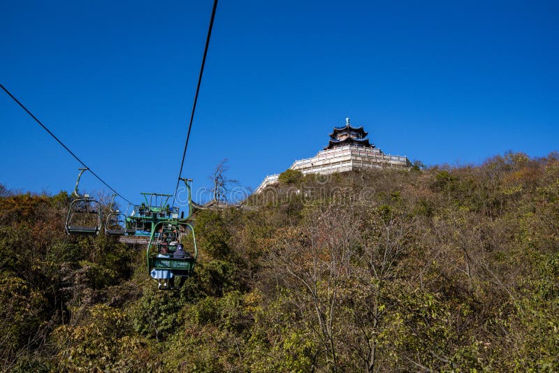 Tourists sitting on the cable car. Cable cars without protective glasses at Tianmenshan, Hunan province, Zhangjiajie. Tourists sitting on the cable car. Cable cars without protective glasses at Tianmenshan, Hunan province, Zhangjiajie.