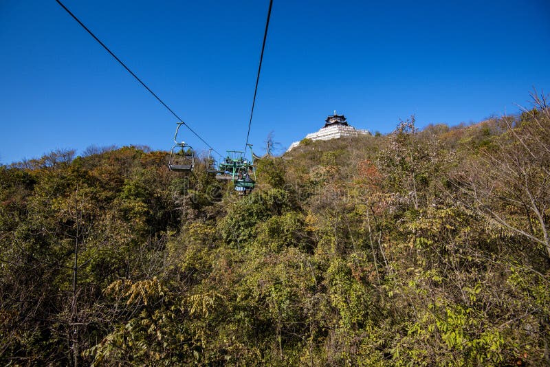 Tourists sitting on the cable car. Cable cars without protective glasses at Tianmenshan, Hunan province, Zhangjiajie. Tourists sitting on the cable car. Cable cars without protective glasses at Tianmenshan, Hunan province, Zhangjiajie.