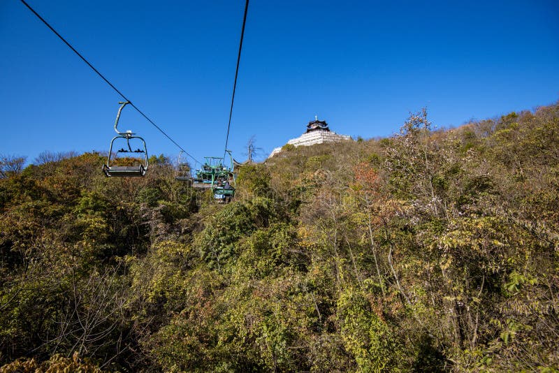 Tourists sitting on the cable car. Cable cars without protective glasses at Tianmenshan, Hunan province, Zhangjiajie. Tourists sitting on the cable car. Cable cars without protective glasses at Tianmenshan, Hunan province, Zhangjiajie.