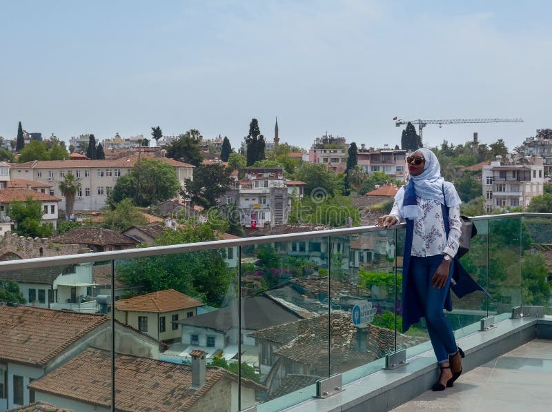 Turkey, Antalya, May 10, 2018. African young woman in beautiful clothes, headscarf and sunglasses standing on the viewing platform royalty free stock images Turkey, Antalya, May 10, 2018. African young woman in beautiful clothes, headscarf and sunglasses standing on the viewing platform royalty free stock images