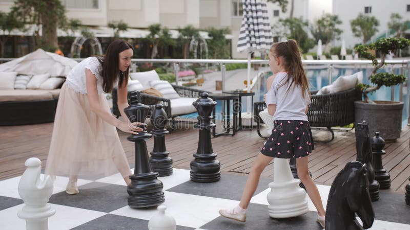 Turkey, Belek - May 20, 2019. Papilon Zeugma Hotel. Playing Outdoor Chess  Large Chess Pieces. Mother and Daughter Stock Video - Video of baby, dress:  160137023