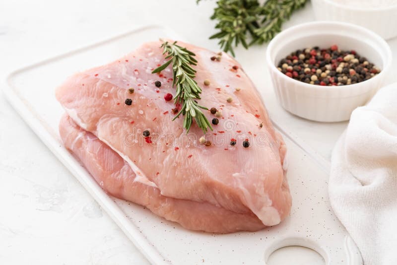 Turkey Breast Raw Meat with Spices on a Dark Background. Copy Space