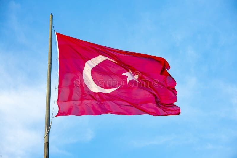Turkey Flag Waving in the Blue Sky with Green Fields at Mountain Peak