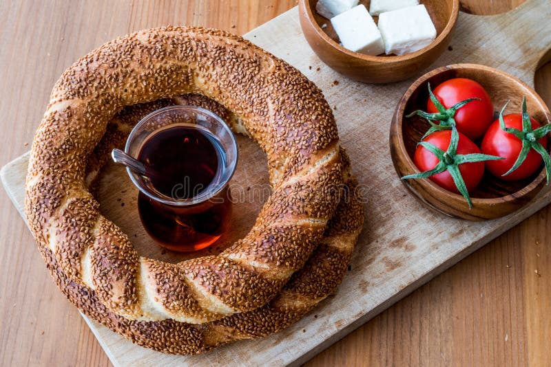 Turkish Bagel Simit with tea, cheese and cherry tomatoes. stock photos