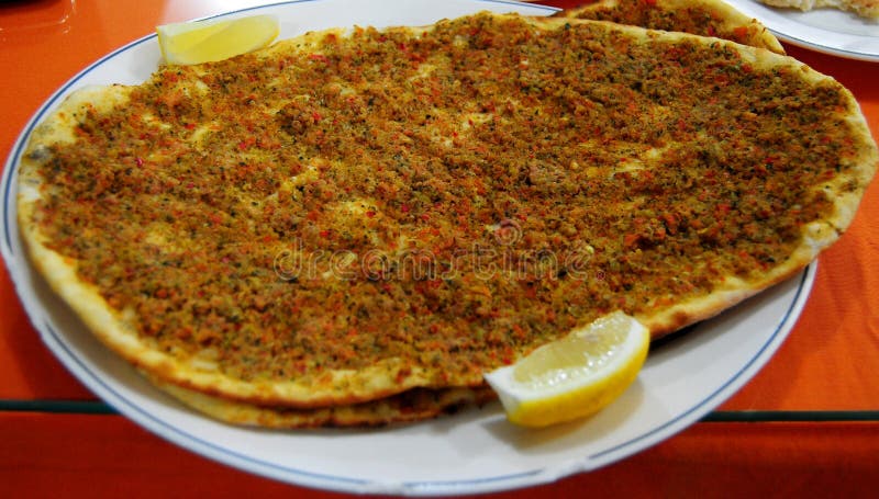 Wood-fired Turkish lahmacun and lemon royalty free stock image