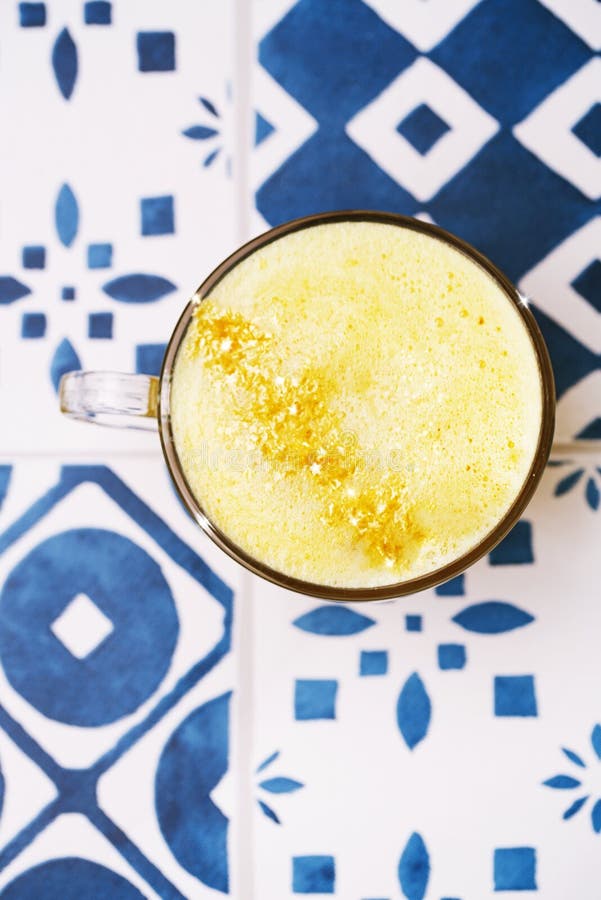 Turmeric latte or golden milk with glitter stars