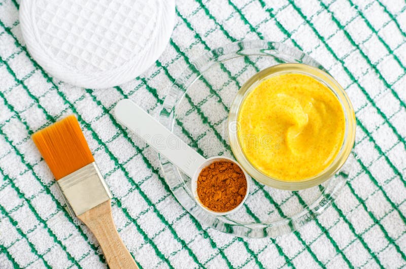 Turmeric powder and greek yogurt sour cream or kefir facial mask. Ingredients for preparing diy face and hair masks royalty free stock photography Turmeric powder and greek yogurt sour cream or kefir facial mask. Ingredients for preparing diy face and hair masks royalty free stock photography