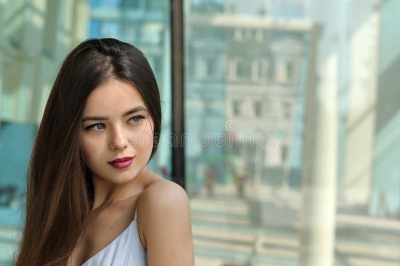 Portrait of a charming young girl with long hair that turned her head