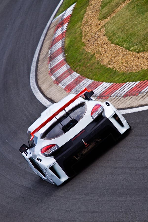 Fast moving touring car speeding around the track. Fast moving touring car speeding around the track