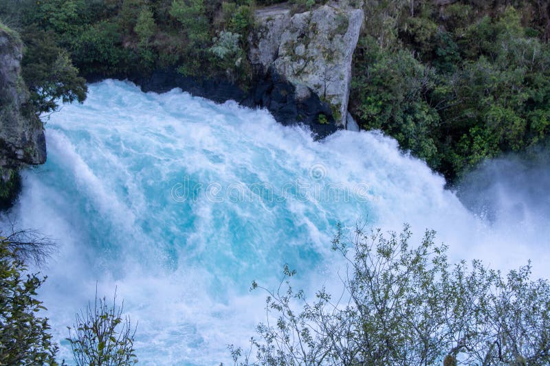 Turquoise Waterfall Cascading Over Rocks royalty free stock photo