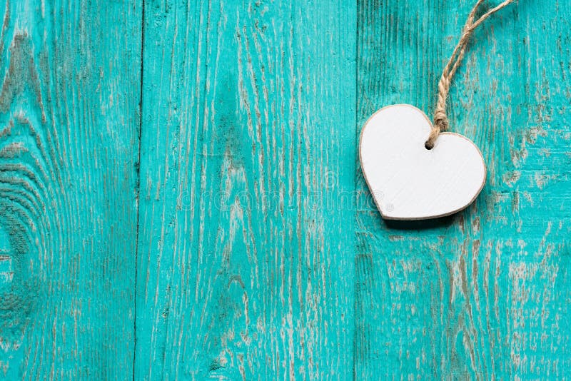 Turquoise wooden floor with a white wooden heart with space for message