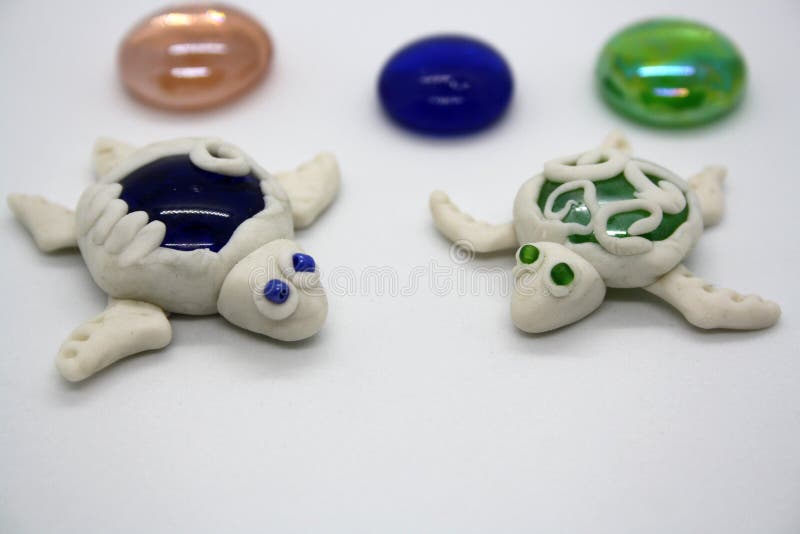A turtle made of polymer clay on a white background. Space for text