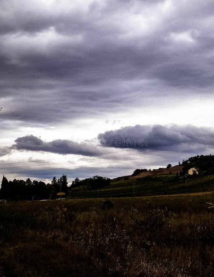 Tuscan field on a cloudy day royalty free stock image