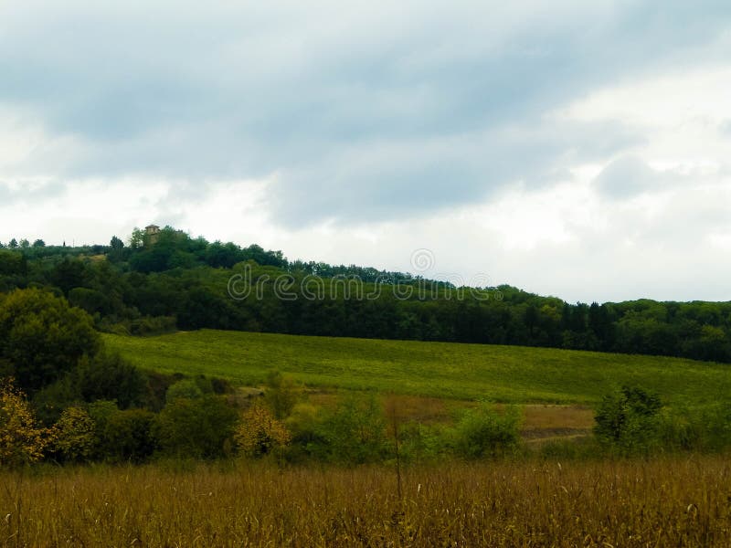 Tuscan field on a cloudy day stock photos