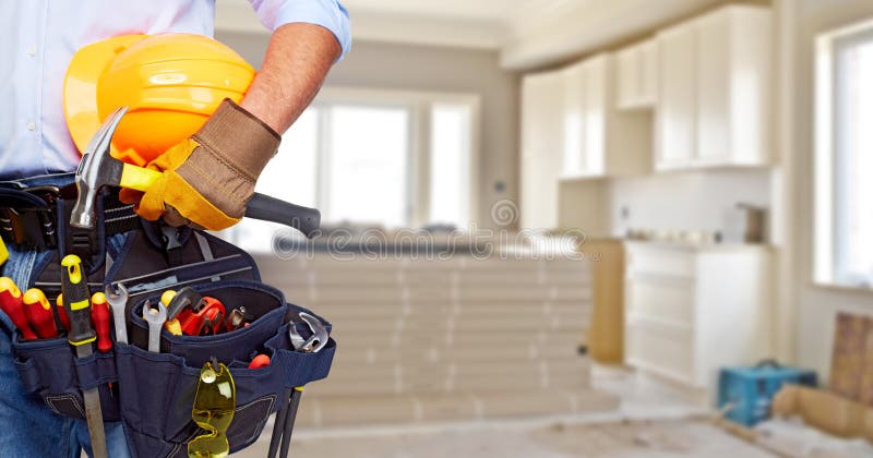 Tuttofare del costruttore con gli strumenti della costruzione immagine stock Tuttofare del costruttore con gli strumenti della costruzione immagine stock