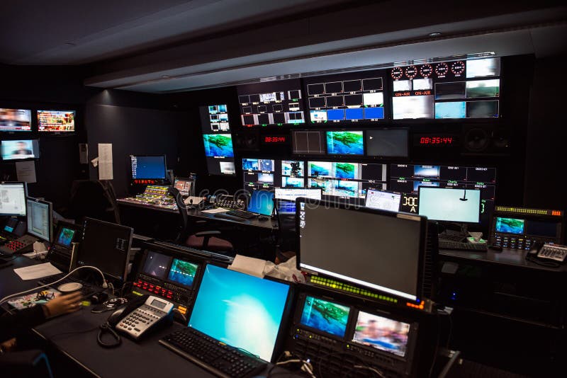 TV Broadcast news studio with many computer screens and control panels for live air broadcast.