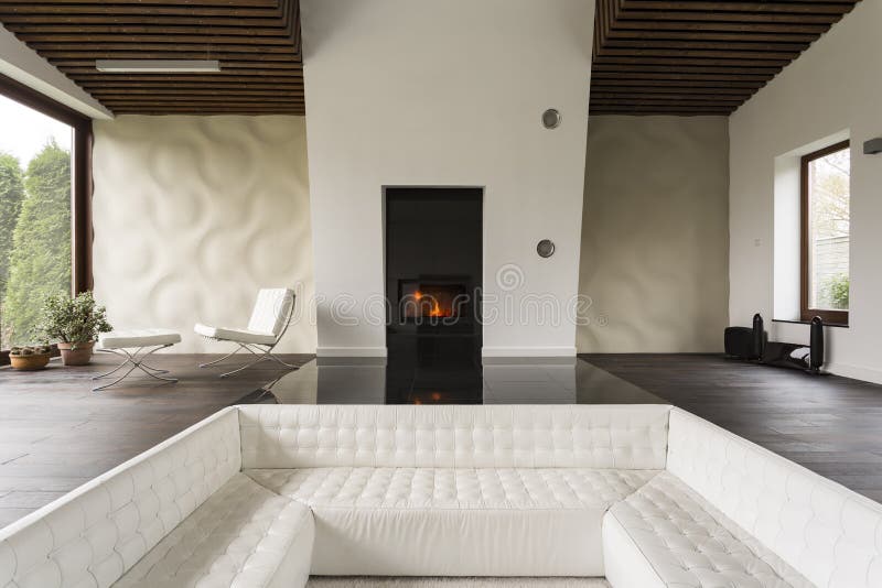 Tv living room with fireplace and extra large white sofa
