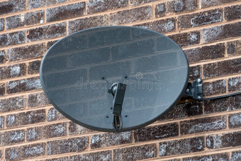TV satellite dish on a brick wall