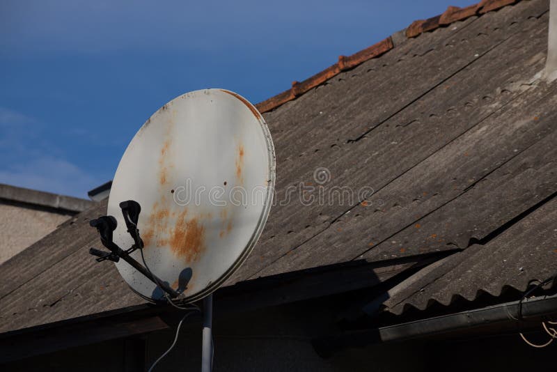 TV Satellite Parabolic Antenna Attached To the Wall of the House Stock
