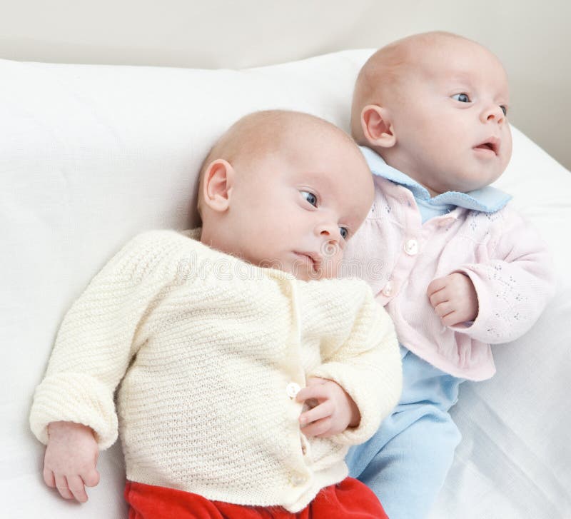 Portrait of twin sisters lying down. Portrait of twin sisters lying down.