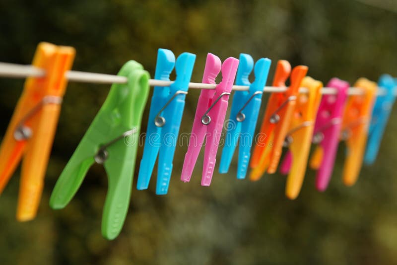Colorful clothes pegs hanging on a laundry line. Colorful clothes pegs hanging on a laundry line