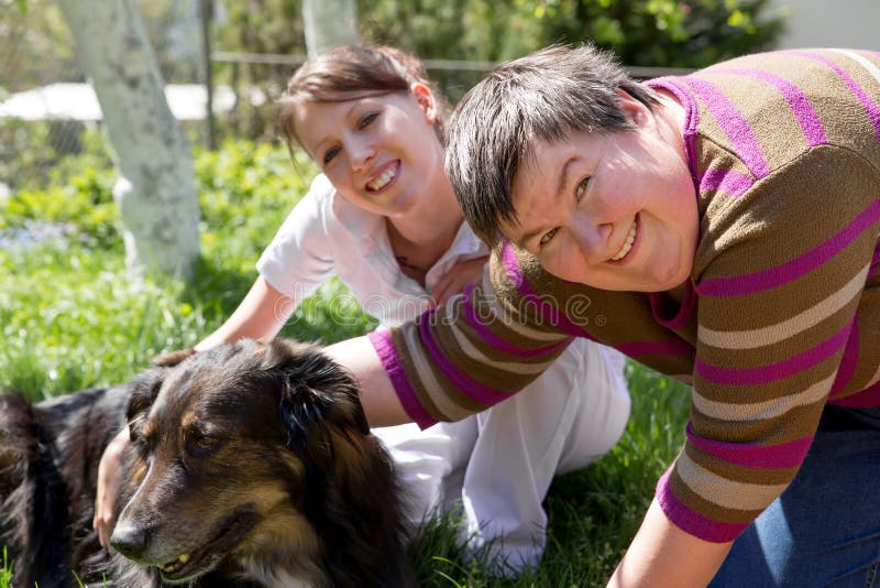 Två kvinnor och en halv avelhund fotografering för bildbyråer Två kvinnor och en halv avelhund fotografering för bildbyråer