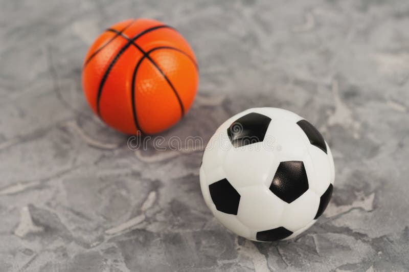 Två nya mjuka rubber fotboll- och basketbollar royaltyfria foton Två nya mjuka rubber fotboll- och basketbollar royaltyfria foton