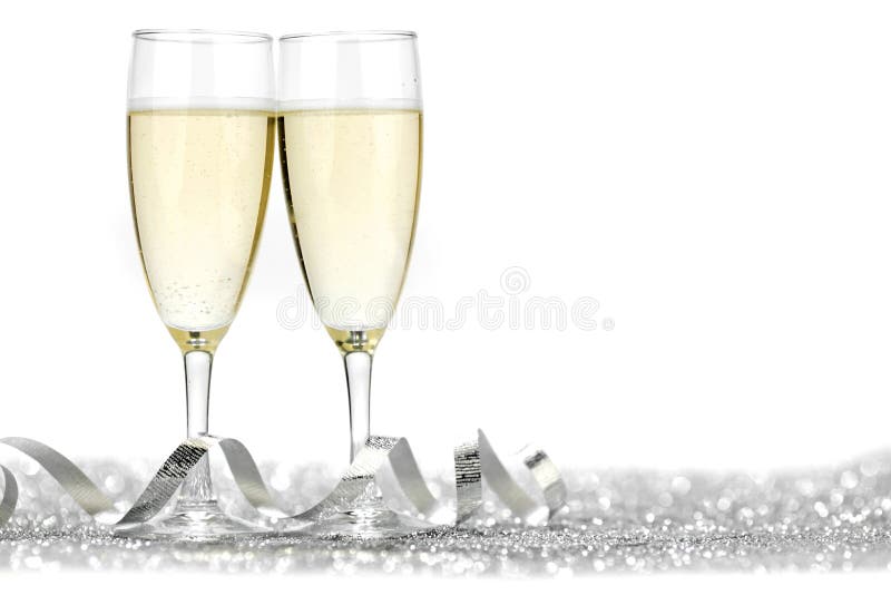 Two champagne flutes and decoration on gold shiny background. Two champagne flutes and decoration on gold shiny background