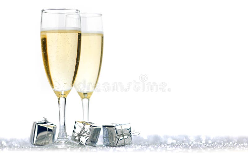 Two champagne flutes and gifts on shiny background. Two champagne flutes and gifts on shiny background