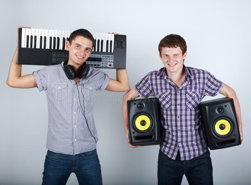 Photo of two funny boys with speakers and piano. Photo of two funny boys with speakers and piano