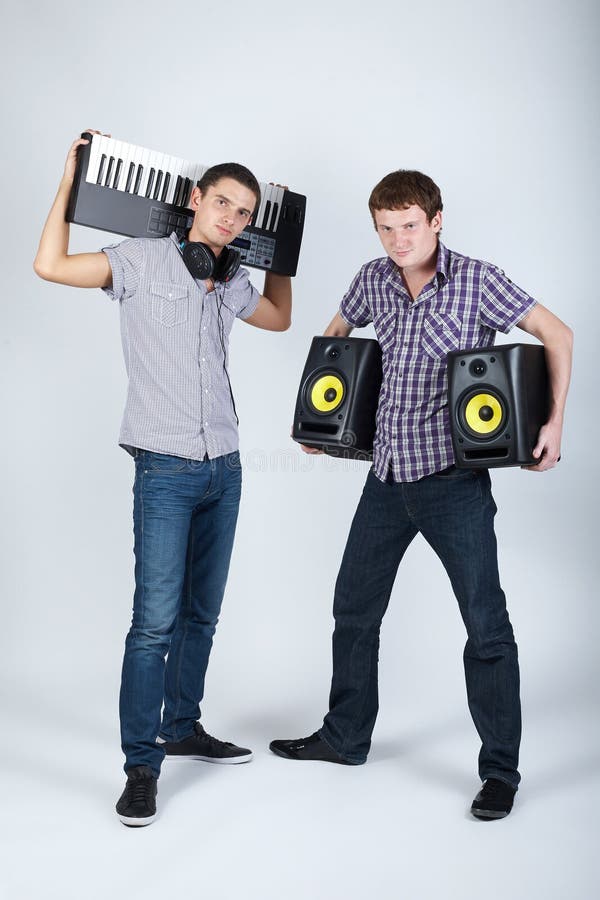 Photo of two funny boys with speakers and piano. Photo of two funny boys with speakers and piano