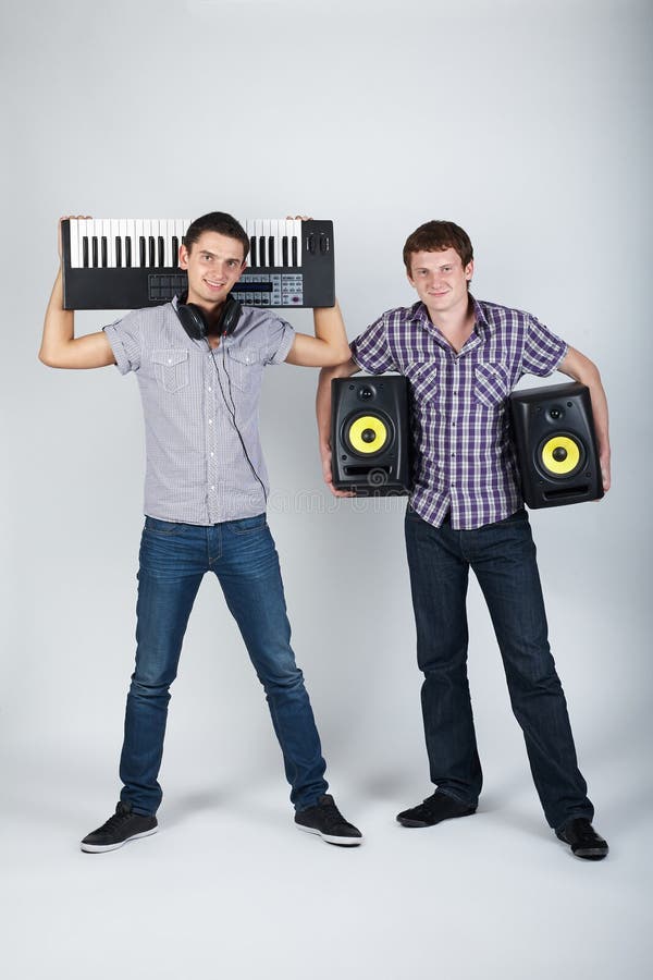 Photo of two funny boys with speakers and piano. Photo of two funny boys with speakers and piano