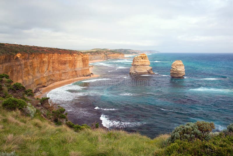 Famous eroded cliffs stacks in ocean waves (Pacific Ocean). 12 Apostles at Great Ocean Road, Victoria, Australia The Twelve Apostles is a collection of limestone stacks off the shore of the Port Campbell National Park, by the Great Ocean Road in Victoria, Australia. Their proximity to one another has made the site a popular tourist attraction. The apostles were formed by erosion: the harsh weather conditions from the Southern Ocean gradually eroded the soft limestone to form caves in the cliffs, which then became arches, which in turn collapsed; leaving rock stacks up to 45 metres high. The site was known as the Sow and Piglets until 1922 (Muttonbird Island, near Loch Ard Gorge, was the Sow, and the smaller rock stacks the Piglets); after which it was renamed to The Apostles for tourism purposes. The formation eventually became known as the Twelve Apostles, despite only ever having nine stacks. In 2002, the Port Campbell Professional Fishermen's Association unsuccessfully attempted to block the creation of a proposed marine national park at the Twelve Apostles location, but were satisfied with the later Victorian Government decision to not allow seismic exploration at the same site by Benaris Energy; believing it would harm marine life. The stacks are susceptible to further erosion from the waves.