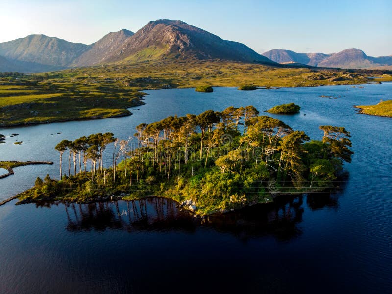 Twelve Pines Island, standing on a gorgeous background formed by the sharp peaks of a mountain range called Twelve Bens, County Ga royalty free stock photography