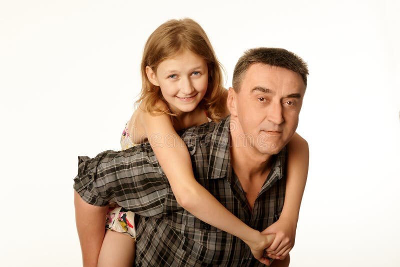 Twelve year old daughter hugging her father sitting on his back royalty free stock photo Twelve year old daughter hugging her father sitting on his back royalty free stock photo