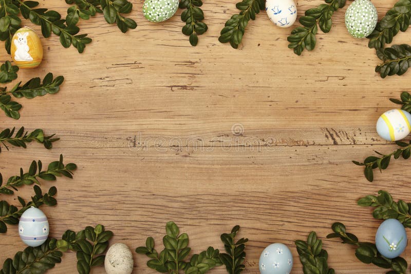 Twigs and easter eggs as frame on wood, copy space royalty free stock photography Twigs and easter eggs as frame on wood, copy space royalty free stock photography