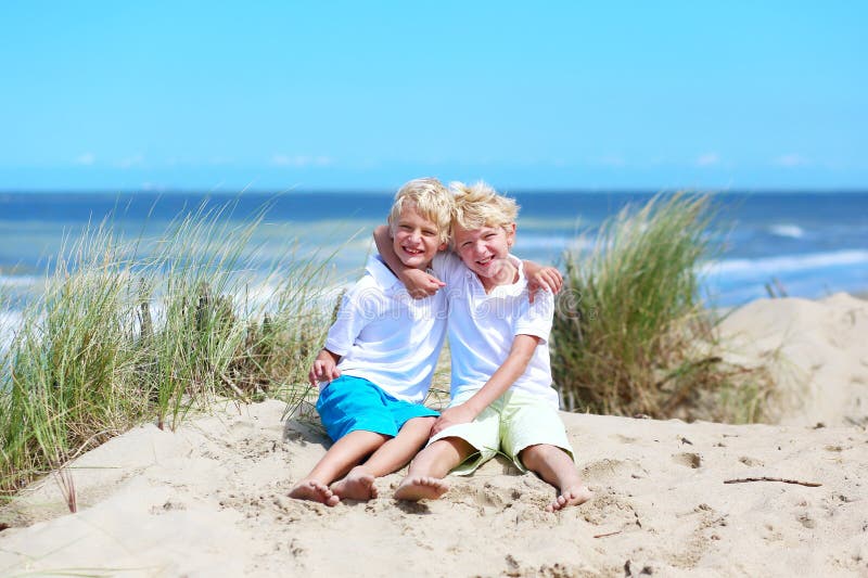 Twin brothers playing on the beach royalty free stock image Twin brothers playing on the beach royalty free stock image