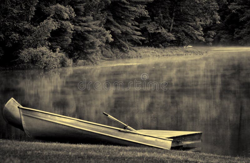 Twin Canoes on Foggy Lake royalty free stock photo
